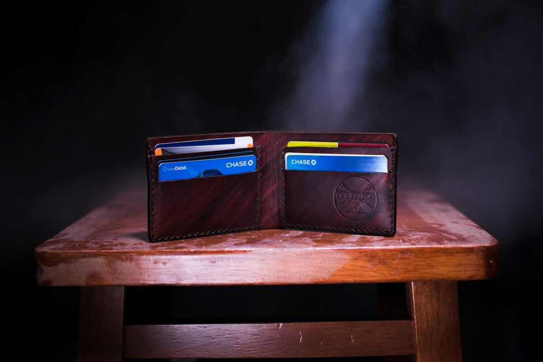 Wallet on a table Photo by Two Paddles Axe and Leatherwork on UnsplashPicture